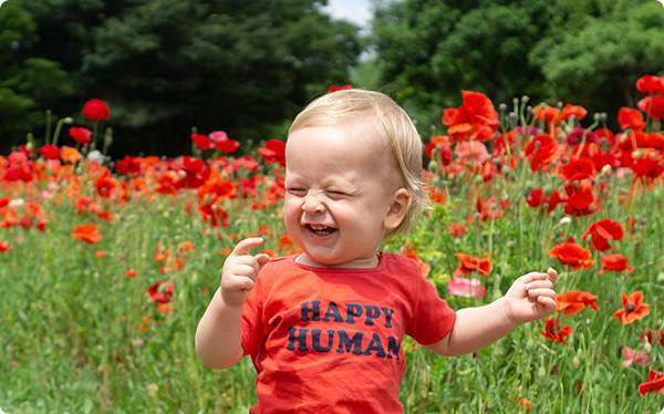 toddler running through poppy field